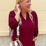 Clear stadium-approved crossbody purse with gold hardware and two strap options, perfect for game days or concerts.