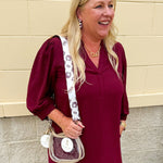 Reversible garnet and gold FSU bag strap with floral print and stripes, featuring brass hardware.