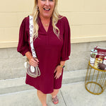 Garnet mini dress with a split U-neckline, flowy fit, and three-quarter peasant sleeves with banded cuffs. Lightweight and perfect for Gameday style.