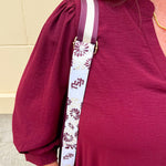 Reversible garnet and gold FSU bag strap with floral print and stripes, featuring brass hardware.