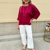 Satin dolman sleeve blouse with a round neckline, shown in a gameday-ready, lightweight and flowy style.