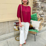 Satin dolman sleeve blouse with a round neckline, shown in a gameday-ready, lightweight and flowy style.