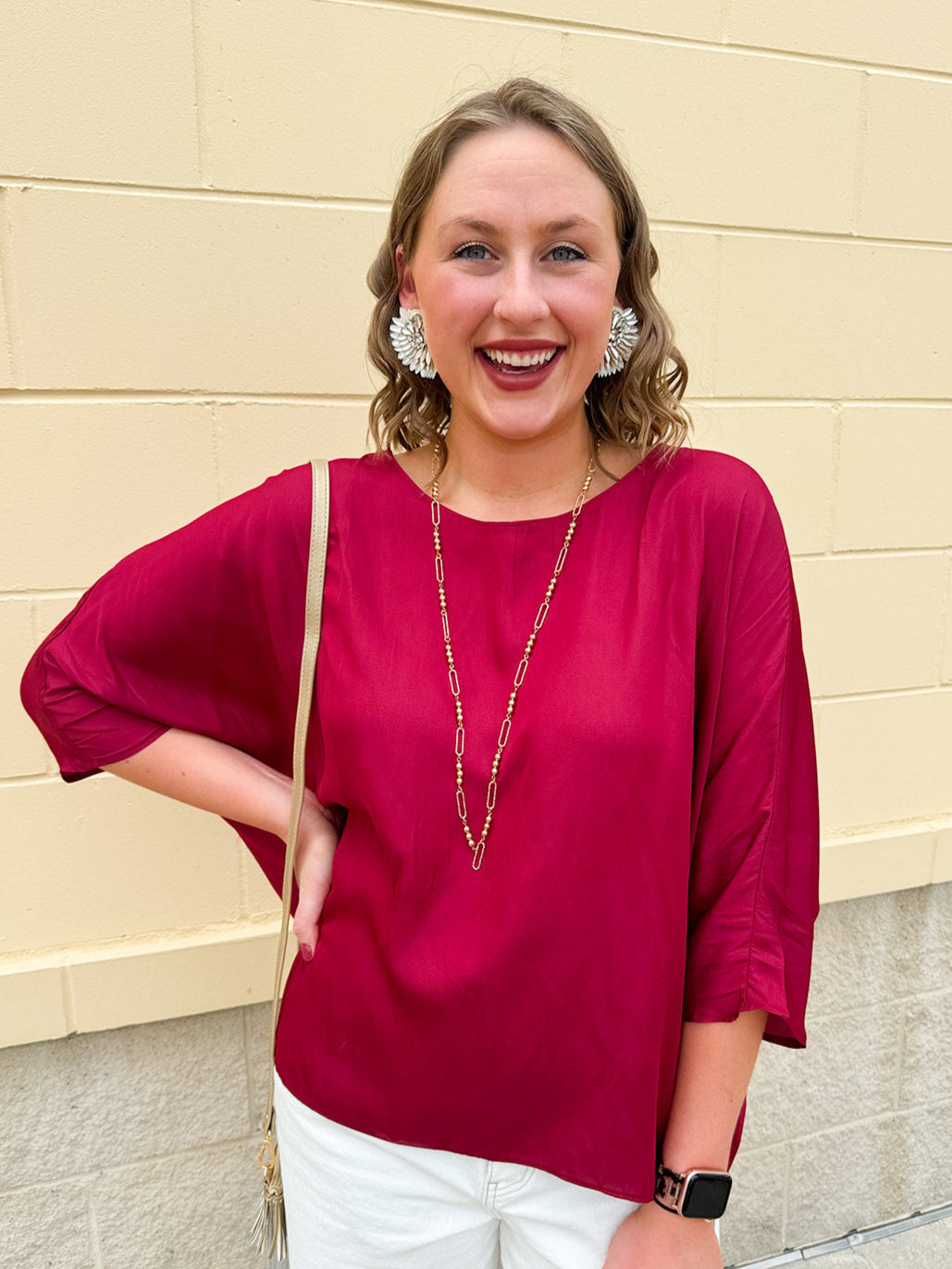 Satin dolman sleeve blouse with a round neckline, shown in a gameday-ready, lightweight and flowy style.