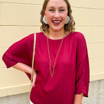 Satin dolman sleeve blouse with a round neckline, shown in a gameday-ready, lightweight and flowy style.