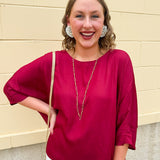 Satin dolman sleeve blouse with a round neckline, shown in a gameday-ready, lightweight and flowy style.