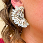 Gold and white feather-inspired earrings with a folded design and silver rhinestone cluster at the stud—lightweight with a bold, elegant look.