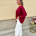 Satin dolman sleeve blouse with a round neckline, shown in a gameday-ready, lightweight and flowy style.