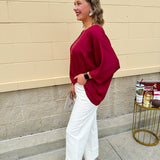 Satin dolman sleeve blouse with a round neckline, shown in a gameday-ready, lightweight and flowy style.