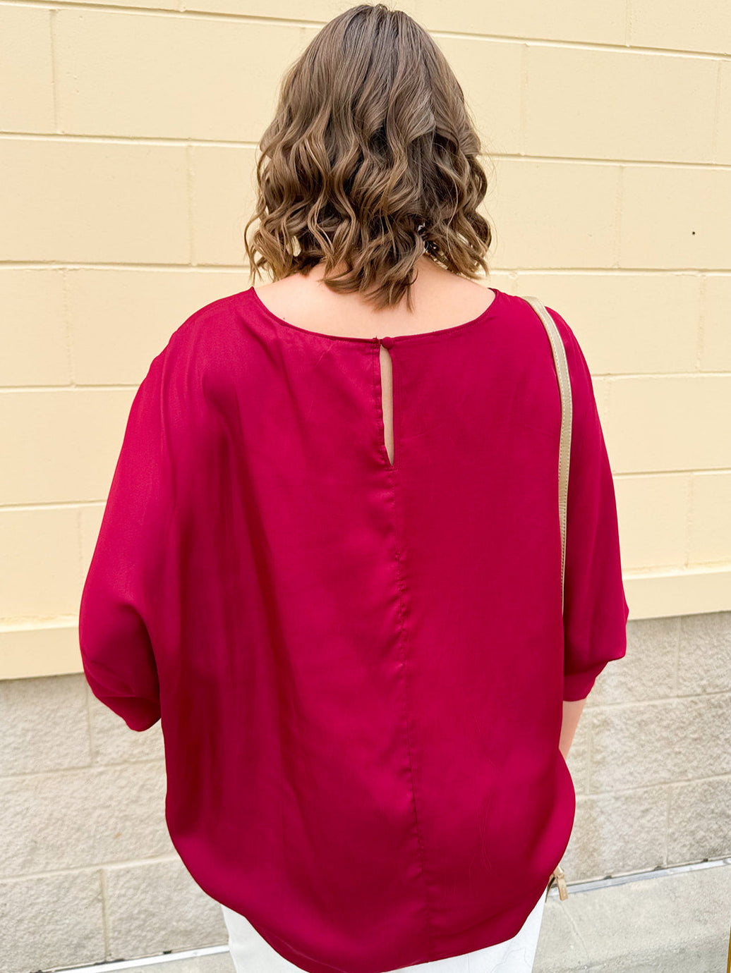 Satin dolman sleeve blouse with a round neckline, shown in a gameday-ready, lightweight and flowy style.