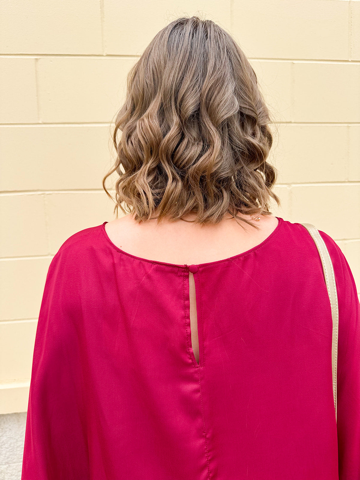 Satin dolman sleeve blouse with a round neckline, shown in a gameday-ready, lightweight and flowy style.
