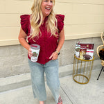Garnet cotton flutter sleeve top with floral appliqué, ruffle V-neck, and button front—lightweight and perfect for gameday