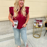 Garnet cotton flutter sleeve top with floral appliqué, ruffle V-neck, and button front—lightweight and perfect for gameday