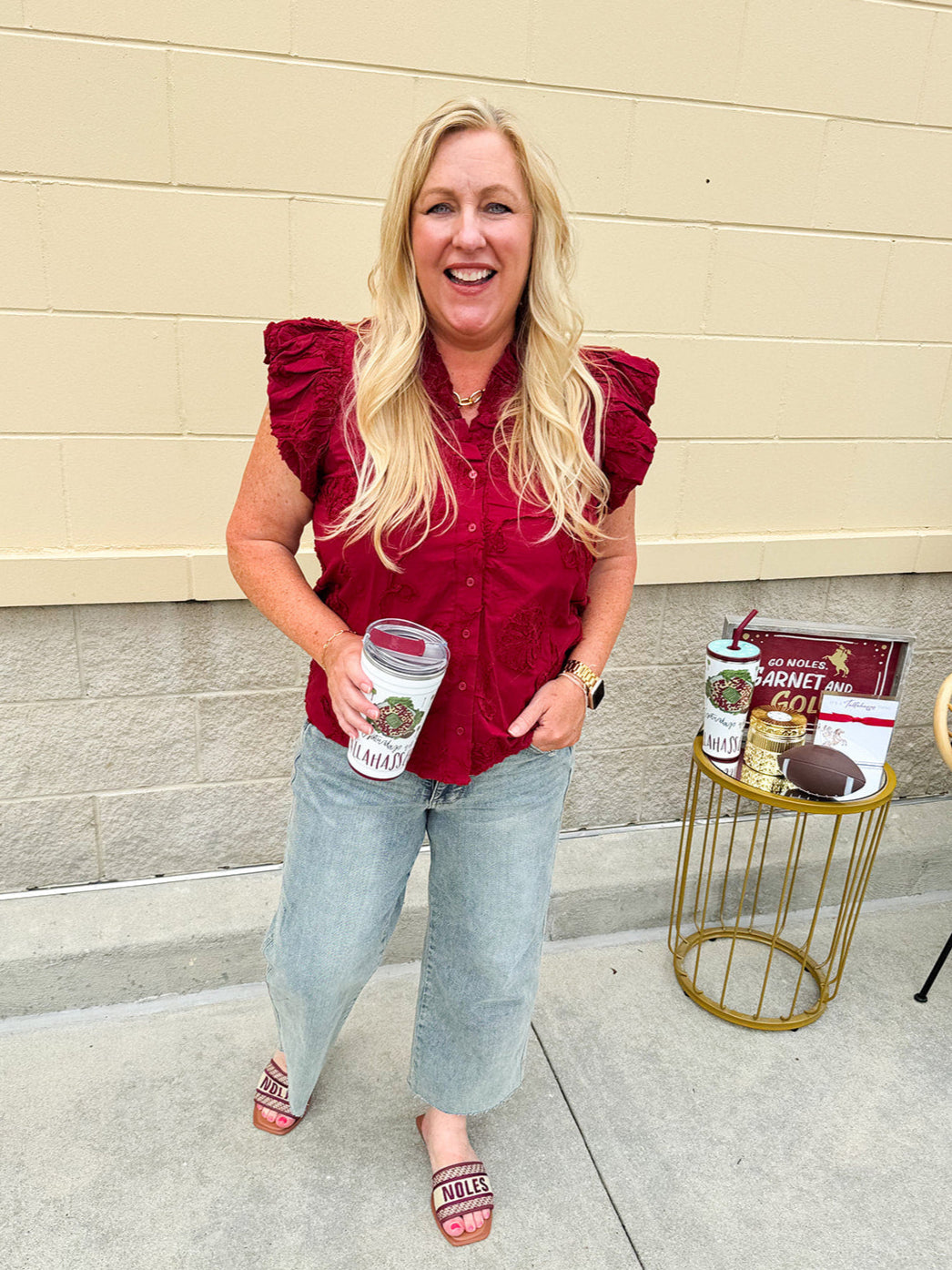 Garnet cotton flutter sleeve top with floral appliqué, ruffle V-neck, and button front—lightweight and perfect for gameday