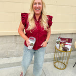 Garnet cotton flutter sleeve top with floral appliqué, ruffle V-neck, and button front—lightweight and perfect for gameday