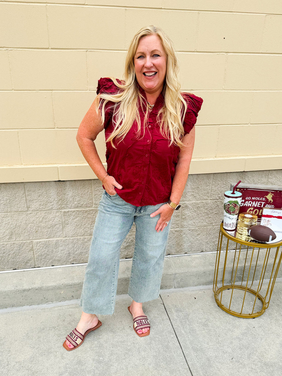 Garnet cotton flutter sleeve top with floral appliqué, ruffle V-neck, and button front—lightweight and perfect for gameday