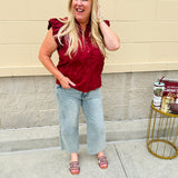 Garnet cotton flutter sleeve top with floral appliqué, ruffle V-neck, and button front—lightweight and perfect for gameday