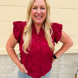 Garnet cotton flutter sleeve top with floral appliqué, ruffle V-neck, and button front—lightweight and perfect for gameday