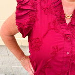 Garnet cotton flutter sleeve top with floral appliqué, ruffle V-neck, and button front—lightweight and perfect for gameday