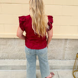Model wearing light wash, cropped wide leg jeans with raw hem and light distressing. Jeans feature a mid-rise waist and tummy control panel.