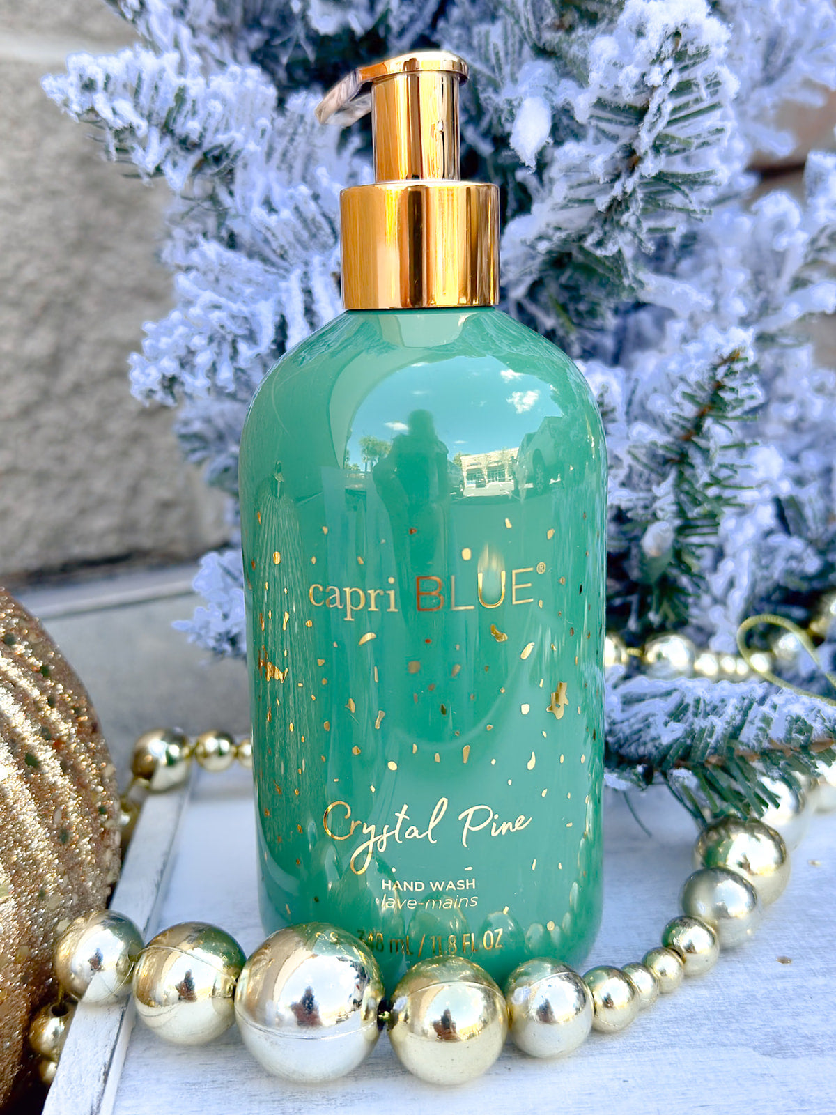 Capri Blue Crystal Pine Hand Wash bottle with green and gold design.