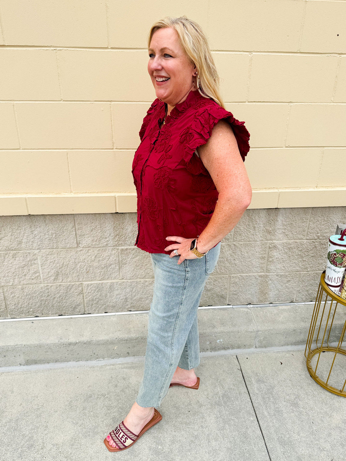 Garnet cotton flutter sleeve top with floral appliqué, ruffle V-neck, and button front—lightweight and perfect for gameday