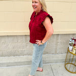 Model wearing light wash, cropped wide leg jeans with raw hem and light distressing. Jeans feature a mid-rise waist and tummy control panel.