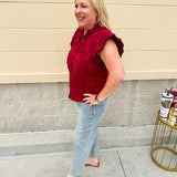 Model wearing light wash, cropped wide leg jeans with raw hem and light distressing. Jeans feature a mid-rise waist and tummy control panel.