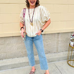 Cream and gold striped round-neck top with dolman sleeves and elastic cuffs, styled for summer.