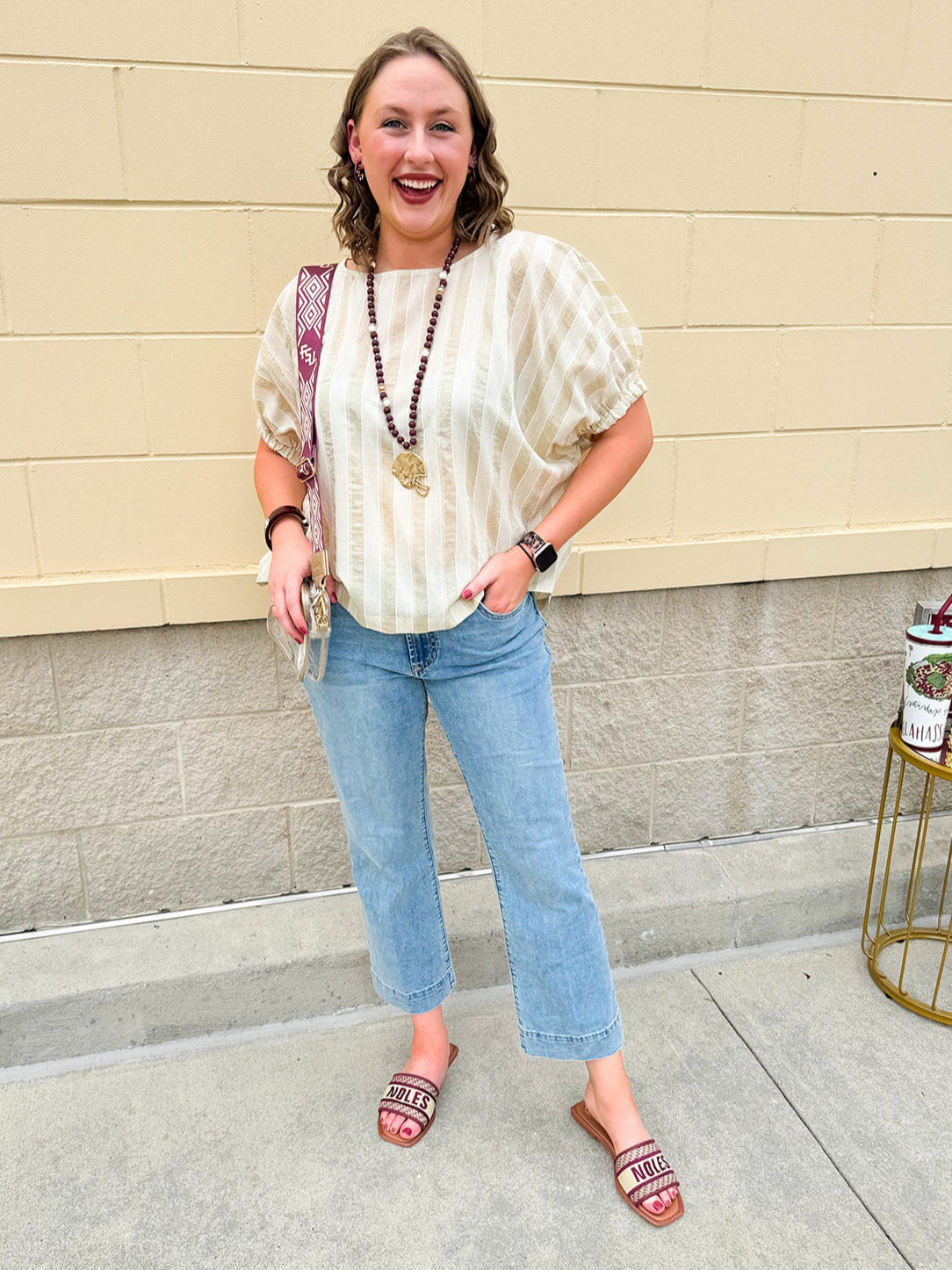 Cream and gold striped round-neck top with dolman sleeves and elastic cuffs, styled for summer.