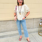 Light wash mid-rise flare jeans with frayed hem and flattering fit, styled for casual and chic everyday looks.