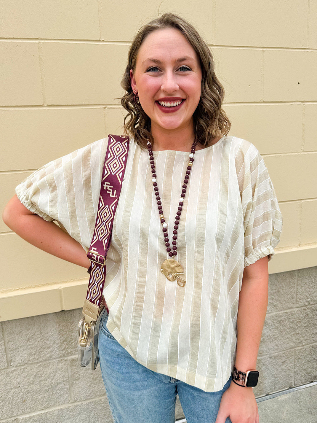 Cream and gold striped round-neck top with dolman sleeves and elastic cuffs, styled for summer.