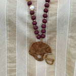 Statement necklace with garnet, white, and gold beads featuring a hammered gold football helmet pendant—perfect for spirited Gameday wear.