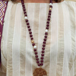 Statement necklace with garnet, white, and gold beads featuring a hammered gold football helmet pendant—perfect for spirited Gameday wear.