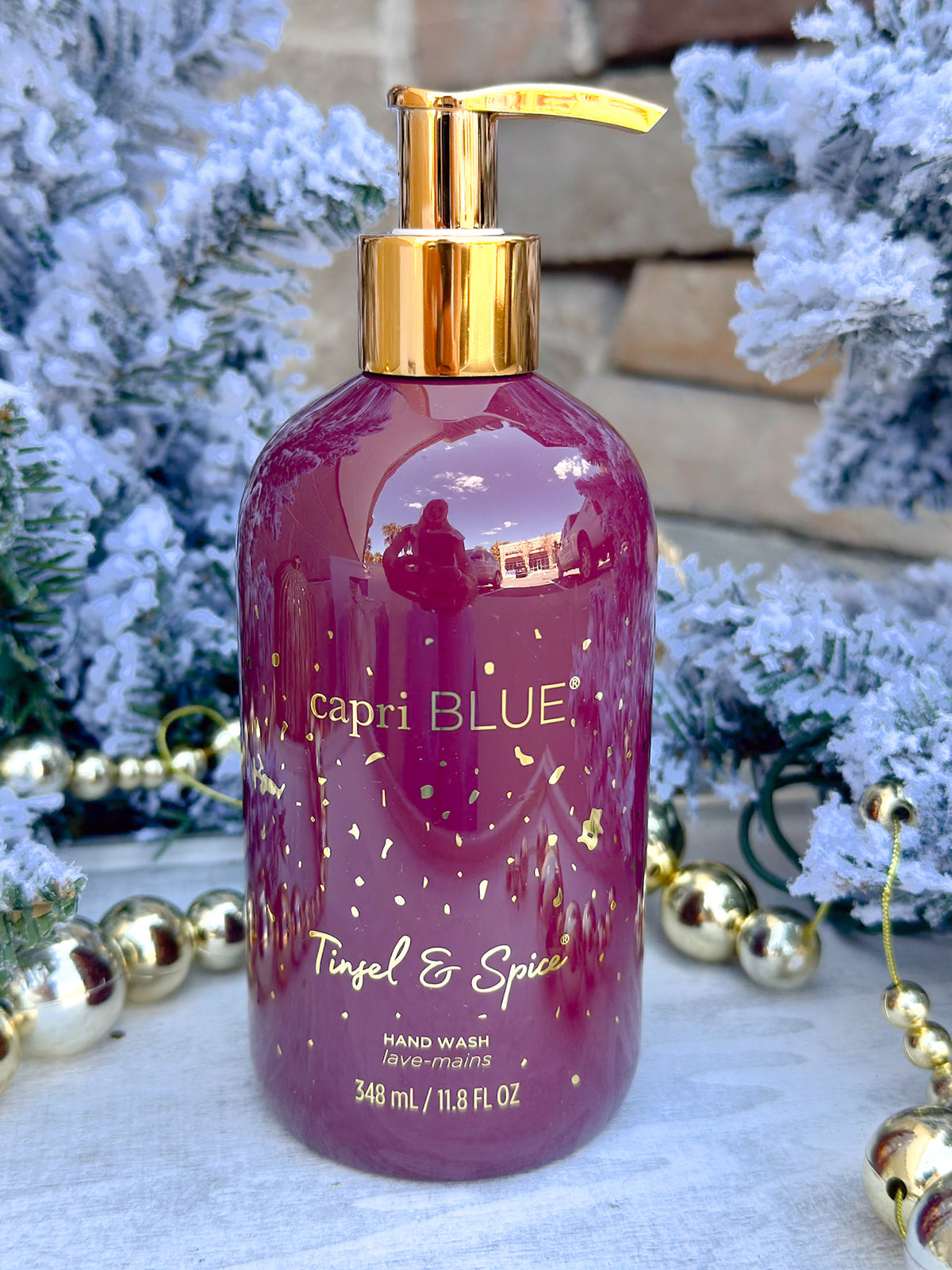 Capri Blue Tinsel & Spice Hand Wash in garnet bottle with gold flecks.