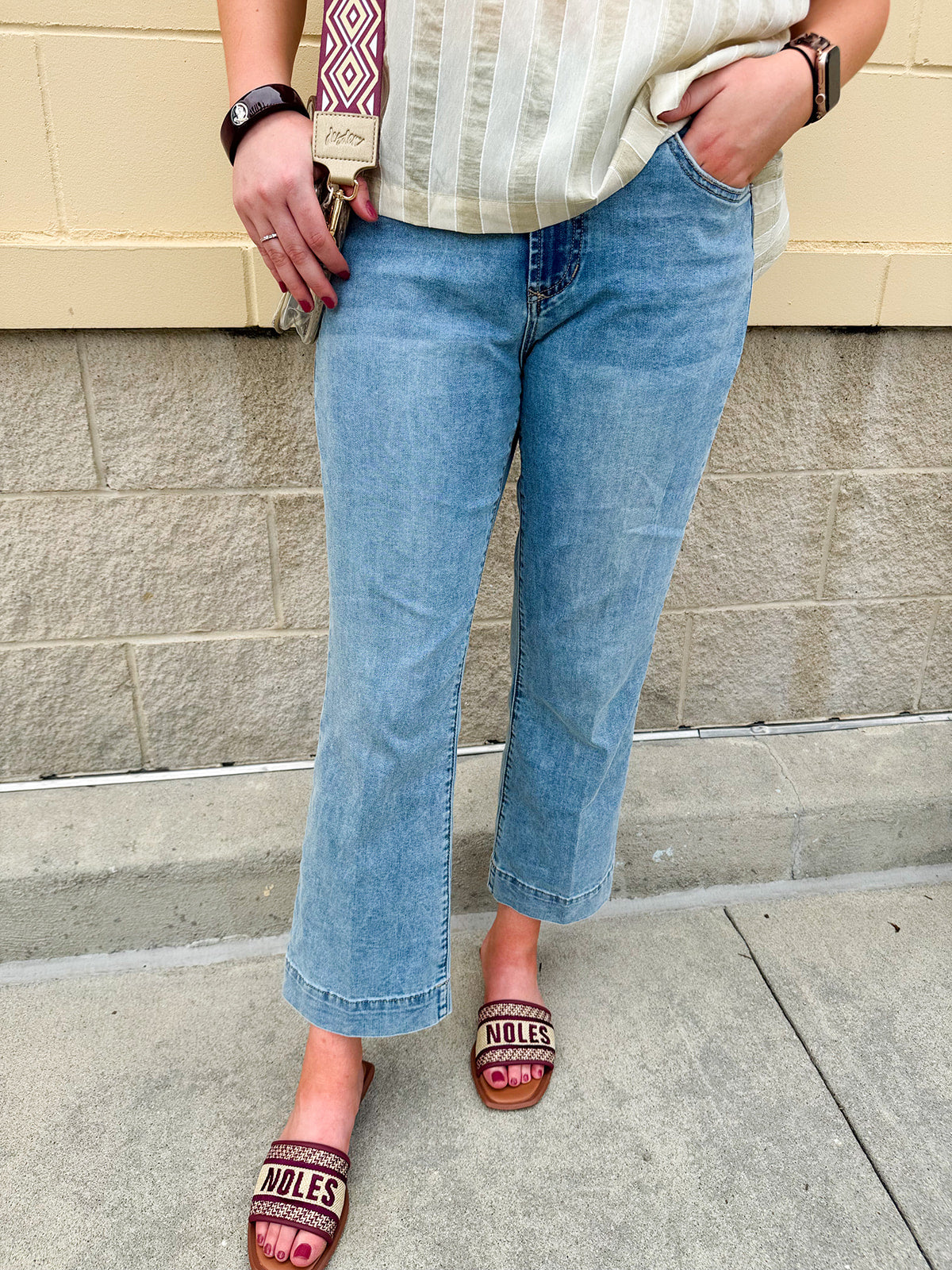 Light wash mid-rise flare jeans with frayed hem and flattering fit, styled for casual and chic everyday looks.