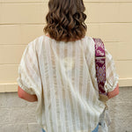 Cream and gold striped round-neck top with dolman sleeves and elastic cuffs, styled for summer.