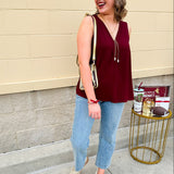 Garnet sleeveless V-neck tank with pleated detail at neckline, made in USA fabric.