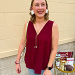 Garnet sleeveless V-neck tank with pleated detail at neckline, made in USA fabric.