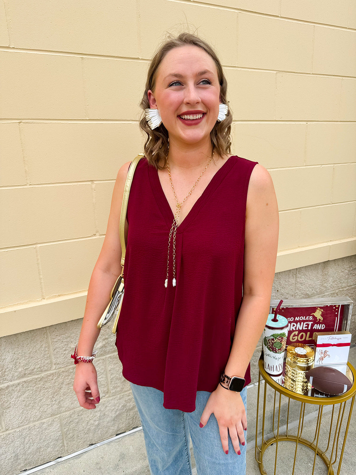 Garnet sleeveless V-neck tank with pleated detail at neckline, made in USA fabric.