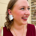Layered feather-style earrings with white and gold sculpted plastic pieces. Bold, lightweight, and perfect for standout Gameday style.