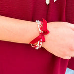 Multi-strand garnet, white, and gold beaded bracelet with satin ribbon tie
