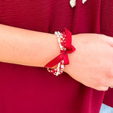 Multi-strand garnet, white, and gold beaded bracelet with satin ribbon tie