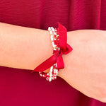 Multi-strand garnet, white, and gold beaded bracelet with satin ribbon tie