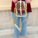Clear crossbody bag with gold faux leather trim and belt buckle accent, perfect for stadium entry.