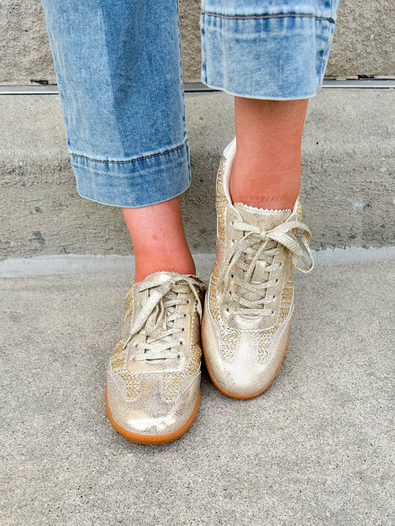 Gold and cream low-top sneaker with subtle metallic sheen, tan sole, and lace-up front—perfect for FSU gameday
