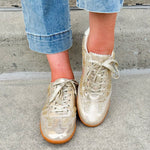Gold and cream low-top sneaker with subtle metallic sheen, tan sole, and lace-up front—perfect for FSU gameday