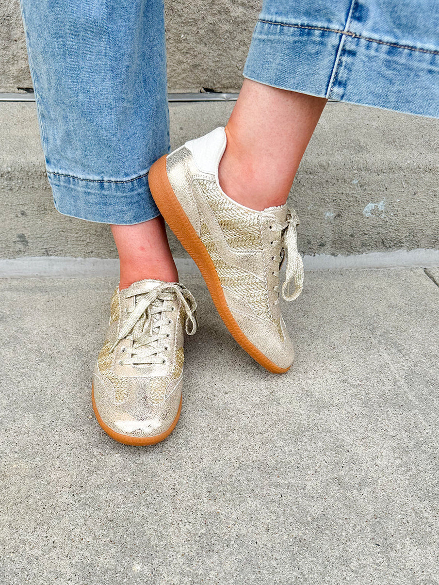 Gold and cream low-top sneaker with subtle metallic sheen, tan sole, and lace-up front—perfect for FSU gameday