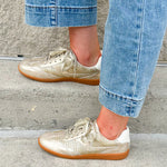 Gold and cream low-top sneaker with subtle metallic sheen, tan sole, and lace-up front—perfect for FSU gameday