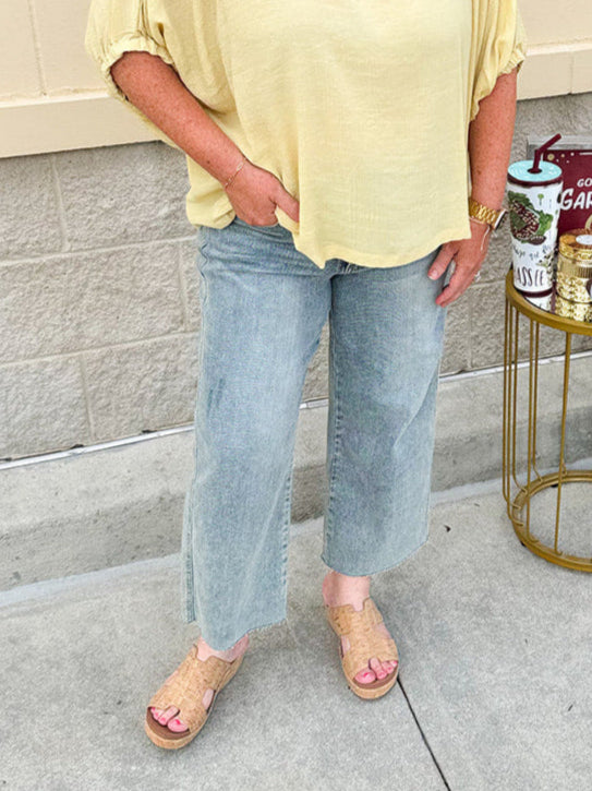 Golden yellow short sleeve blouse with a relaxed fit and dolman sleeves, styled for casual or dressy occasions.