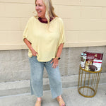 Golden yellow short sleeve blouse with a relaxed fit and dolman sleeves, styled for casual or dressy occasions.